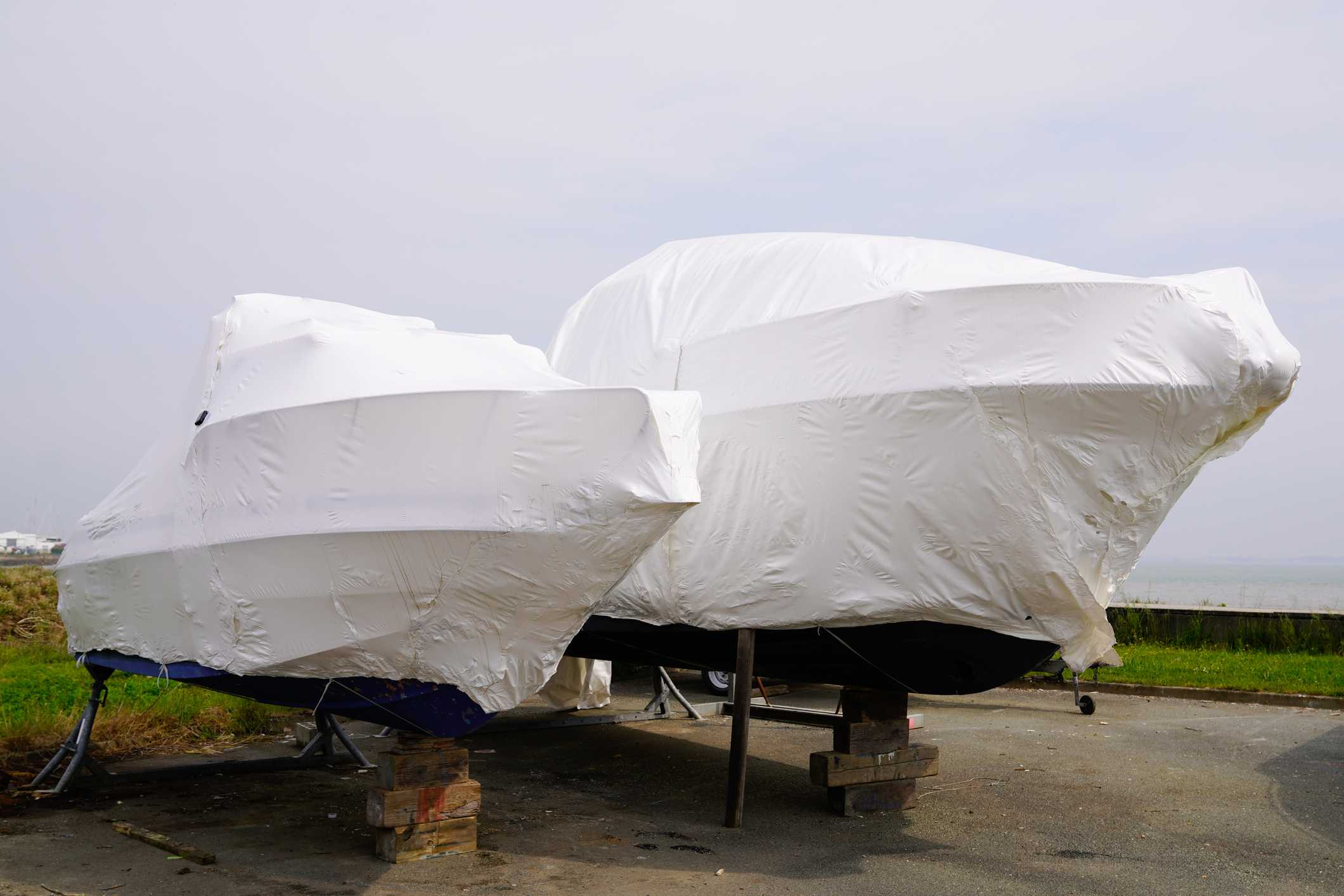 Power Boat Parked Water Protected By Plastic Film For Wintering New Boats In Cover Casing Shrink Wrap On Sailboat Stored For Winter